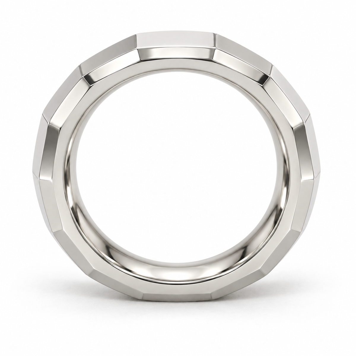 [metal:white-gold] Alden Faceted Band — top — Broad polished facets with bevelled edges and a smooth rounded interior, circular elevation studio view [catalog-v4]