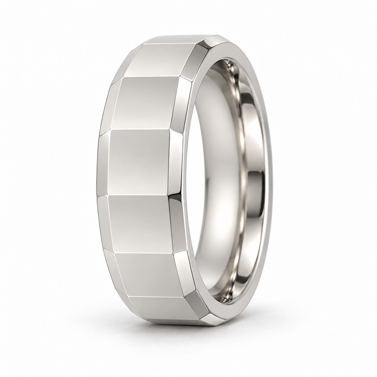 [metal:white-gold] Alden Faceted Band — three-quarter — Broad polished facets with bevelled edges and a smooth rounded interior, upright oblique studio view [catalog-v4]