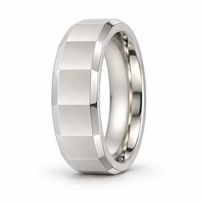 [metal:white-gold] Alden Faceted Band — three-quarter — Broad polished facets with bevelled edges and a smooth rounded interior, upright oblique studio view [catalog-v4]