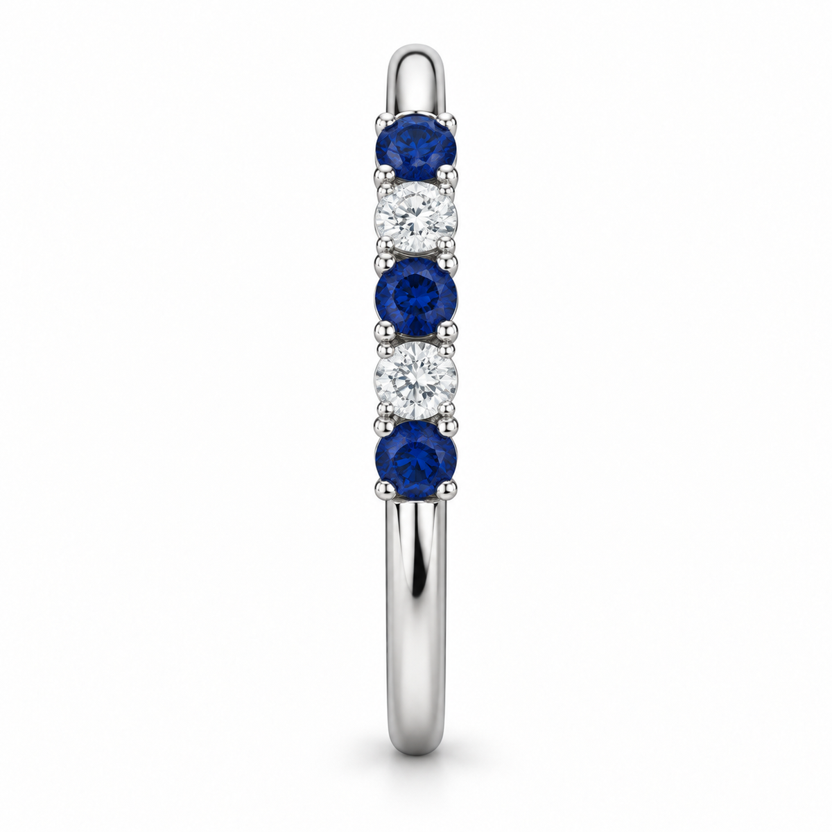 [metal:white-gold] Amelie Sapphire Accent Band — side-profile — slender polished band with five round stones across front ordered blue sapphire white diamond blue sapphire white diamond blue sapphire, side-profile view [catalog-v4]