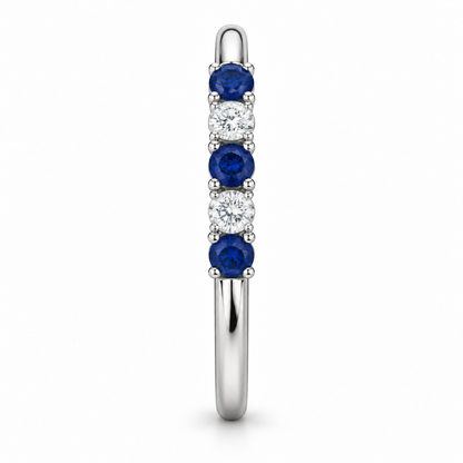 [metal:white-gold] Amelie Sapphire Accent Band — side-profile — slender polished band with five round stones across front ordered blue sapphire white diamond blue sapphire white diamond blue sapphire, side-profile view [catalog-v4]