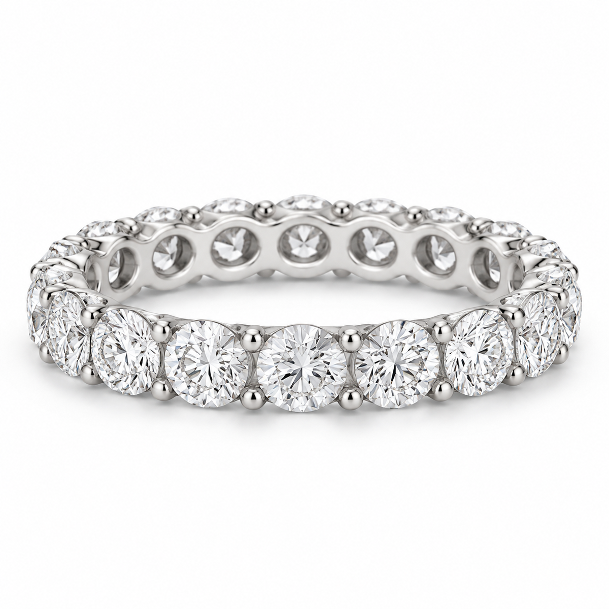 [metal:white-gold] Aveline Round Eternity Ring — front — Shared-prong round diamond eternity ring, shallow front studio view [catalog-v4]
