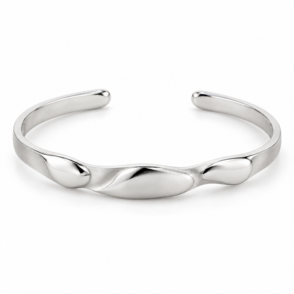 [metal:white-gold] Beliora Pebble Cuff — front — One open oval solid cuff with three shallow smooth asymmetric pebble lobes sculpted into its front surface, seamlessly joined to a single continuous narrow flat satin cuff. Rounded polished tips, rear opening, no floating links and no stones. [catalog-v4]
