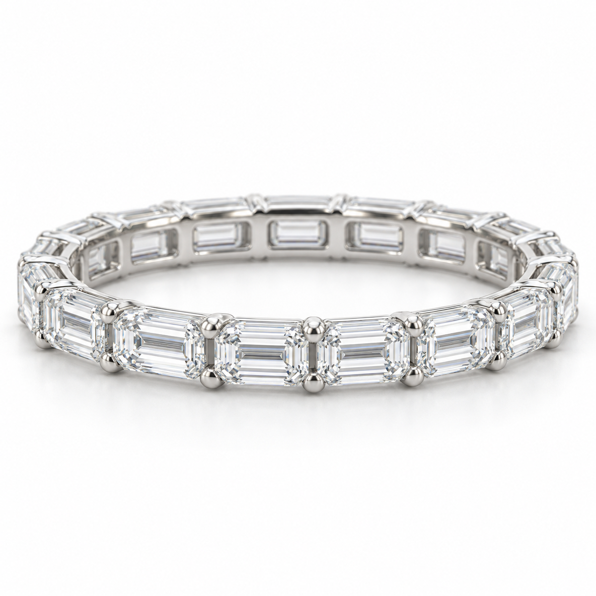 [metal:white-gold] Brielle Emerald Eternity Ring — front — East-west emerald-cut diamond eternity ring, shallow front studio view [catalog-v4]