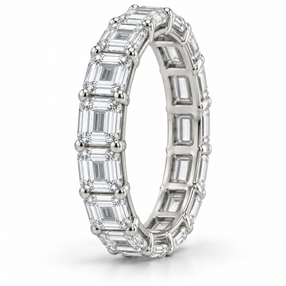 [metal:white-gold] Brielle Emerald Eternity Ring — three-quarter — East-west emerald-cut diamond eternity ring, standing oblique studio view [catalog-v4]