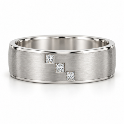 [metal:white-gold] Cedric Diagonal Trio Band — front — broad brushed white gold band with exactly three small square princess diamonds flush set in a diagonal line across central front face, thin polished edges, front view [catalog-v4]