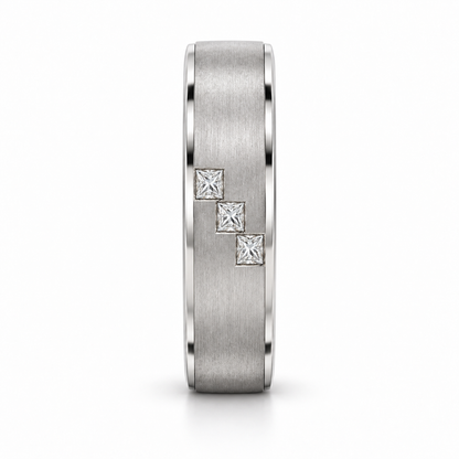 [metal:white-gold] Cedric Diagonal Trio Band — side-profile — broad brushed white gold band with exactly three small square princess diamonds flush set in a diagonal line across central front face, thin polished edges, side-profile view [catalog-v4]