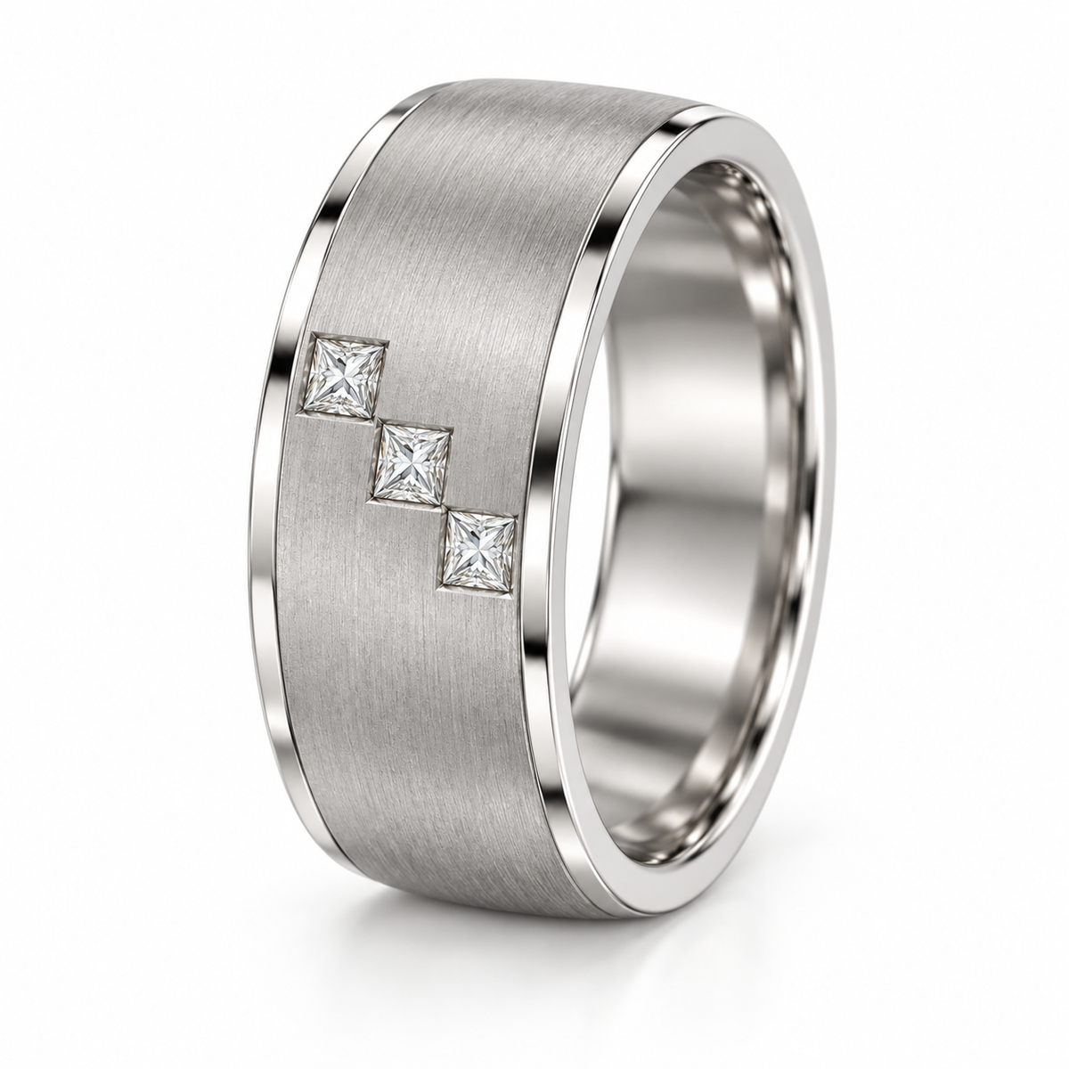 [metal:white-gold] Cedric Diagonal Trio Band — three-quarter — broad brushed white gold band with exactly three small square princess diamonds flush set in a diagonal line across central front face, thin polished edges, three-quarter view [catalog-v4]