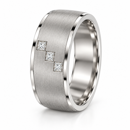 [metal:white-gold] Cedric Diagonal Trio Band — three-quarter — broad brushed white gold band with exactly three small square princess diamonds flush set in a diagonal line across central front face, thin polished edges, three-quarter view [catalog-v4]