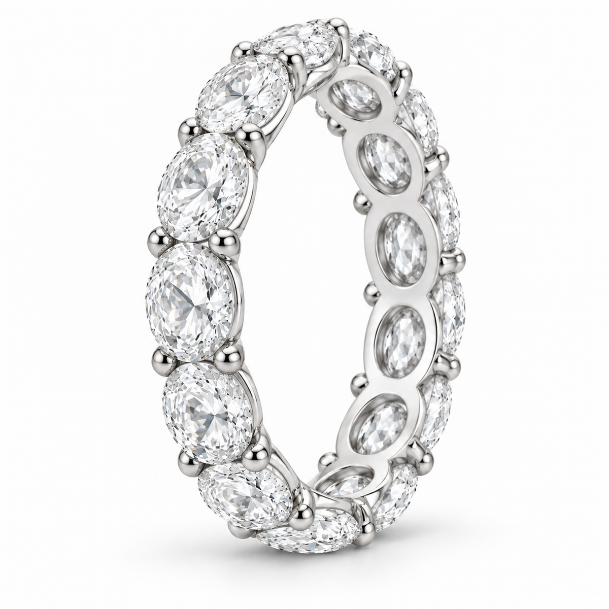 [metal:white-gold] Colette Oval Eternity Ring — three-quarter — Oval diamond eternity ring, standing oblique studio view [catalog-v4]