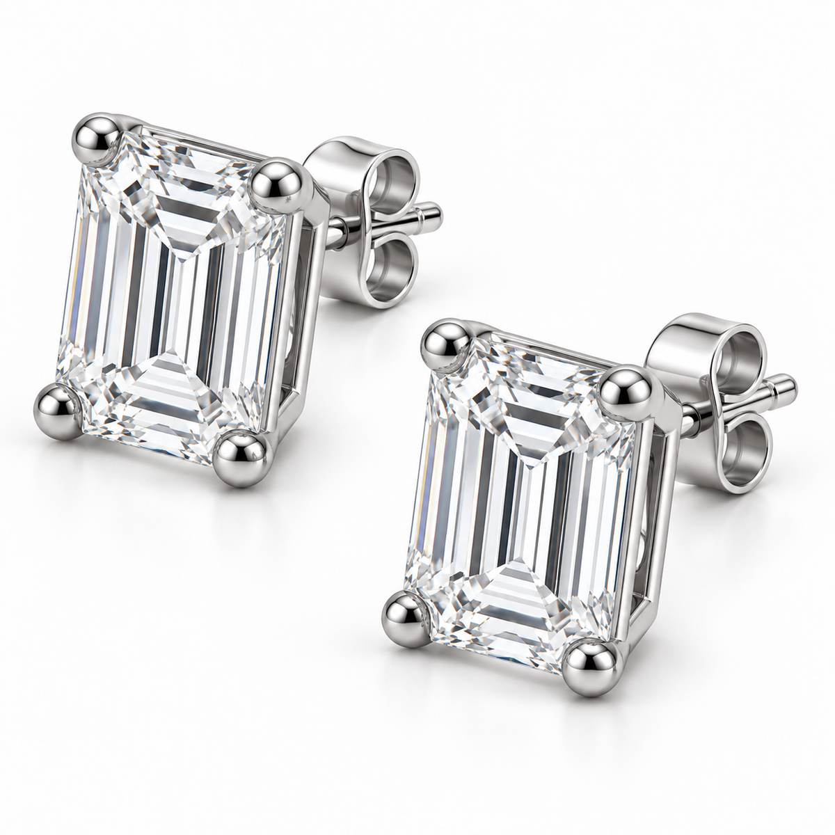 [metal:white-gold] Estelle Emerald-Cut Studs — three-quarter — Oblique view showing baskets and butterfly backs [catalog-v4]