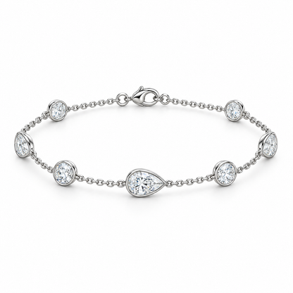[metal:white-gold] Evangeline Station Bracelet — front — Alternating pear and round diamond station bracelet, low oblique studio view [catalog-v4]