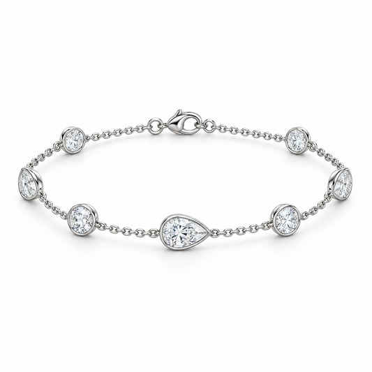 [metal:white-gold] Evangeline Station Bracelet — front — Alternating pear and round diamond station bracelet, low oblique studio view [catalog-v4]