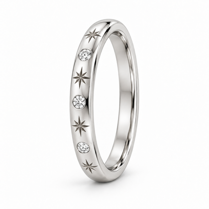 [metal:white-gold] Freya Celestial Ring — three-quarter — Star-engraved diamond band, standing oblique studio view [catalog-v4]