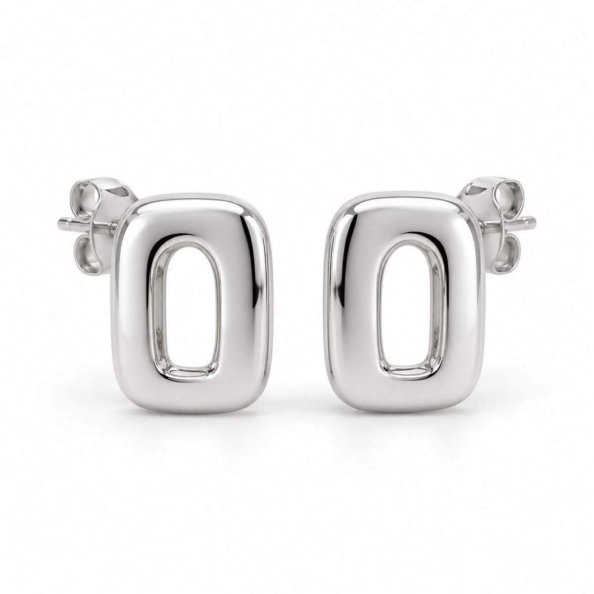 [metal:white-gold] Ilorine Arc-Window Studs — front — Matching pair of small thick polished rounded-rectangle metal studs, each has one narrow curved arch-shaped open window through centre. Smooth solid outer perimeter, straight rear posts and butterfly backs. No stones. [catalog-v4]