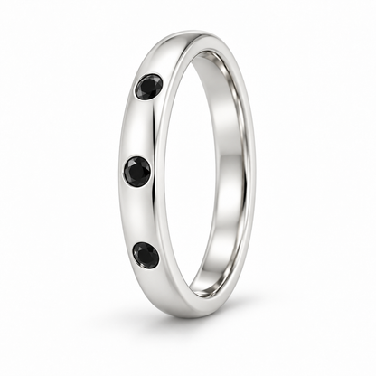 [metal:white-gold] Ione Black Diamond Ring — three-quarter — Flush-set black diamond band, standing oblique studio view [catalog-v4]