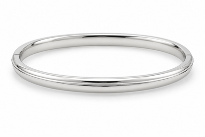 [metal:white-gold] Isola Hinged Oval Bangle — front — plain polished oval hinged bangle with a subtle raised centre ridge and hidden clasp, no stones, front view [catalog-v4]