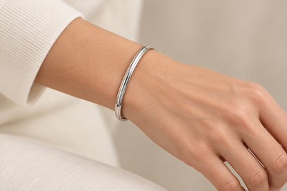 [metal:all] Isola Hinged Oval Bangle — worn — Human-worn styling illustration [catalog-v4]