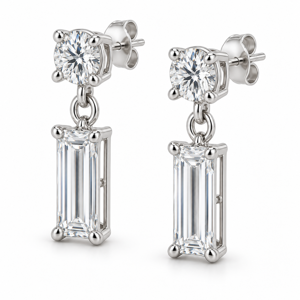 [metal:white-gold] Leonie Baguette Drop Earrings — three-quarter — one small round diamond stud above one vertical baguette diamond drop on each earring, three-quarter view [catalog-v4]