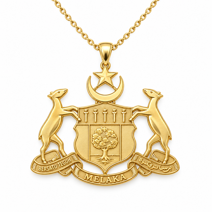 Melaka Emblem Pendant — front, yellow gold; any chain shown is an optional styling accessory