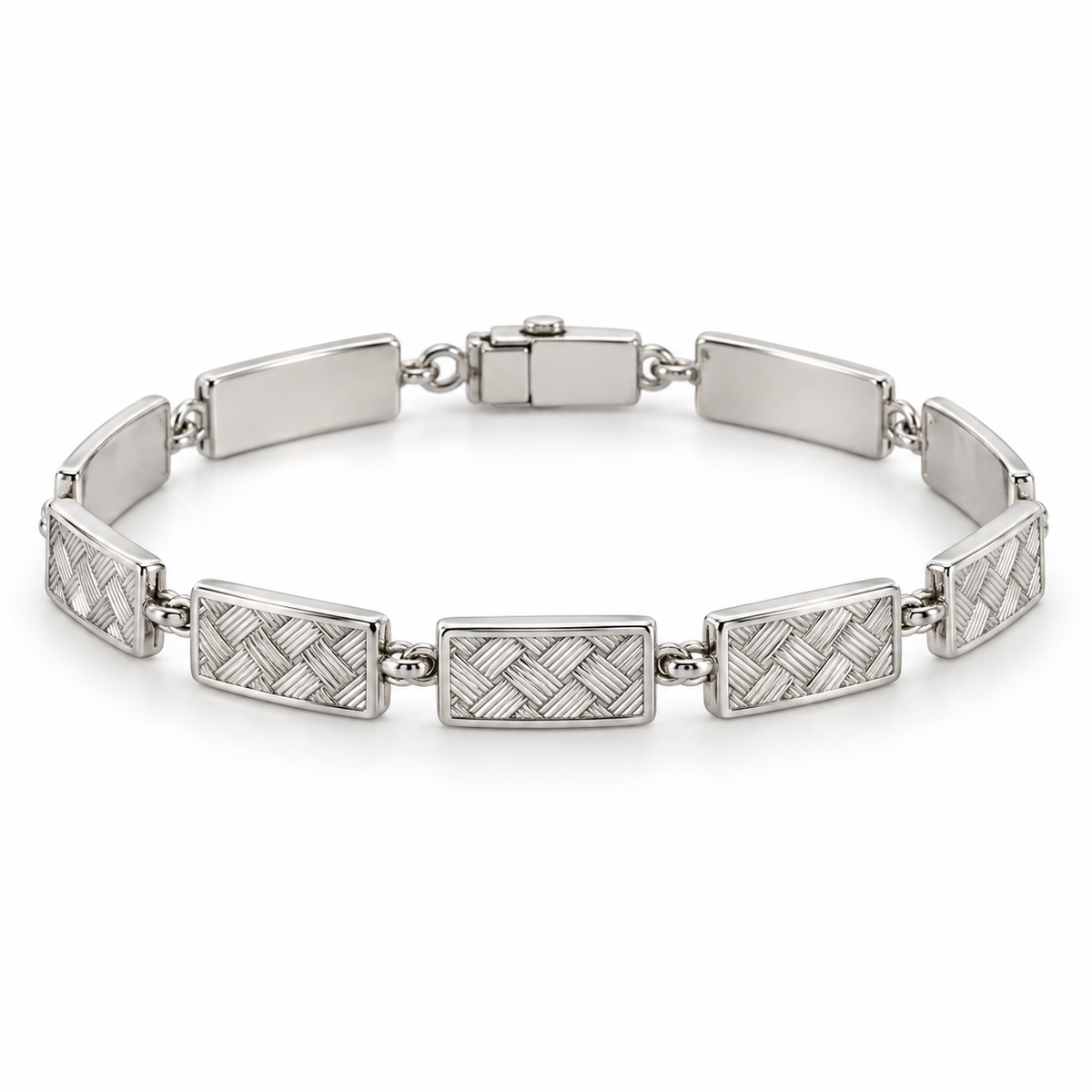 [metal:white-gold] Miravelle Woven-Panel Bracelet — front — Articulated bracelet of exactly seven short solid rectangular panels. Each panel has a low relief engraved diagonal basket-weave pattern, smooth polished border and plain back, joined by simple short oval links. Low box clasp at rear. No diamonds. [catalog-v4]