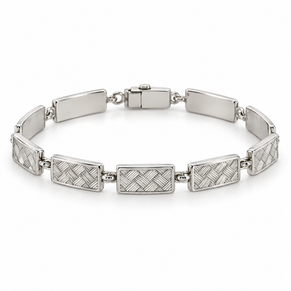 [metal:white-gold] Miravelle Woven-Panel Bracelet — front — Articulated bracelet of exactly seven short solid rectangular panels. Each panel has a low relief engraved diagonal basket-weave pattern, smooth polished border and plain back, joined by simple short oval links. Low box clasp at rear. No diamonds. [catalog-v4]