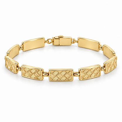 [metal:yellow-gold] Miravelle Woven-Panel Bracelet — front — Articulated bracelet of exactly seven short solid rectangular panels. Each panel has a low relief engraved diagonal basket-weave pattern, smooth polished border and plain back, joined by simple short oval links. Low box clasp at rear. No diamonds. [catalog-v4]