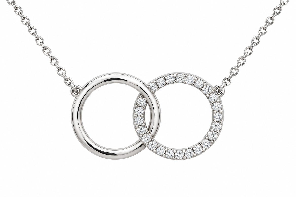 [metal:white-gold] Mirelle Double Circle Necklace — front — two small interlocking circular pendants one plain polished and one fine round-diamond pave, fine chain attached at upper outer sides, front view [catalog-v4]