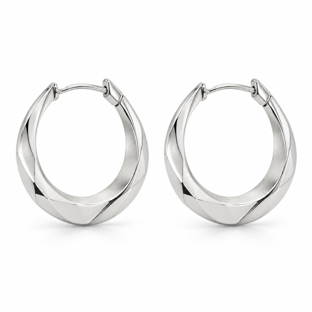 [metal:white-gold] Naverie Facet Crescent Hoops — front — Matching pair of small hinged crescent hoops with solid triangular faceted metal cross-section, narrow at ends and broader along lower front arc. Polished exterior facets, satin inner facet, hinged rear latch. No stones, no open front gap when closed. [catalog-v4]