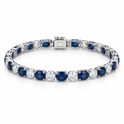 [metal:white-gold] Noelle Sapphire Tennis Bracelet — front — Alternating sapphire and diamond tennis bracelet, low oblique studio view [catalog-v4]