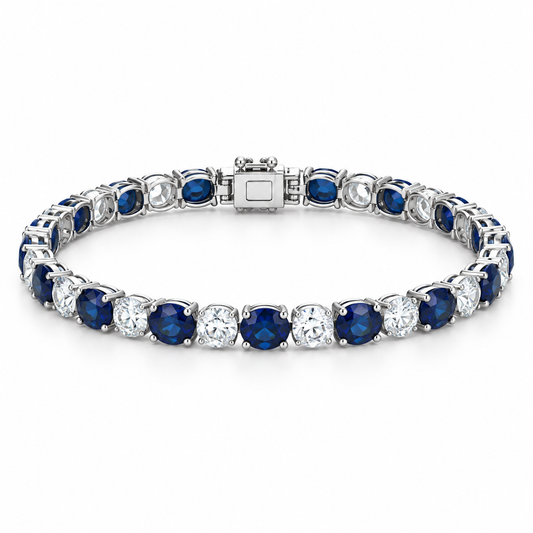 [metal:white-gold] Noelle Sapphire Tennis Bracelet — front — Alternating sapphire and diamond tennis bracelet, low oblique studio view [catalog-v4]