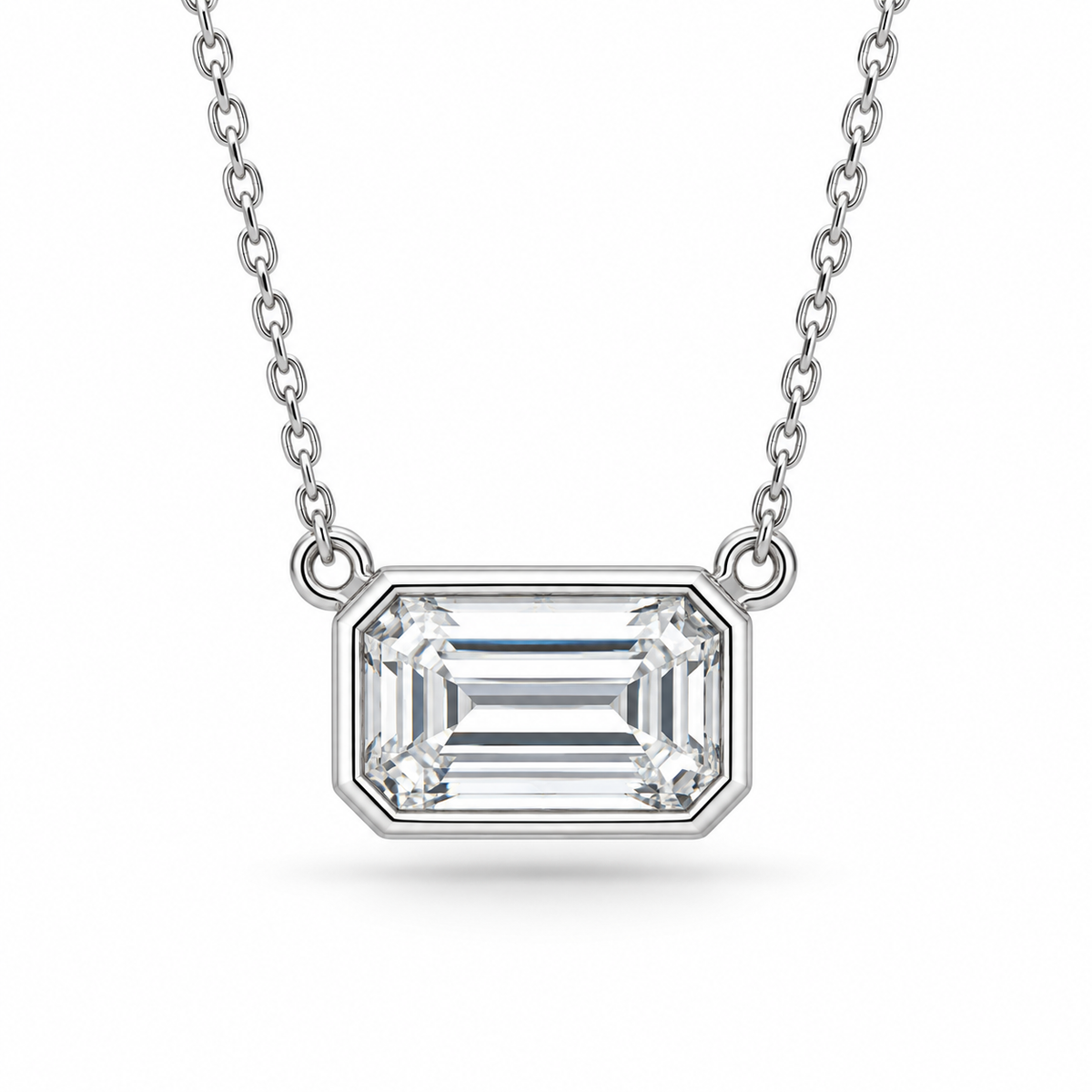 [metal:white-gold] Odette Emerald Pendant — front — East-west emerald-cut bezel pendant, front studio view [catalog-v4]