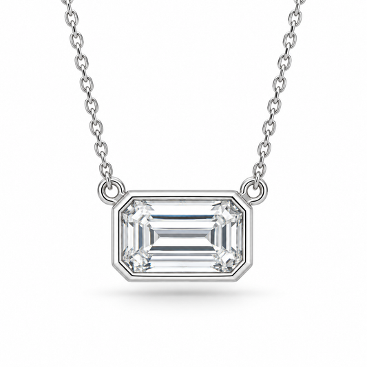 [metal:white-gold] Odette Emerald Pendant — front — East-west emerald-cut bezel pendant, front studio view [catalog-v4]