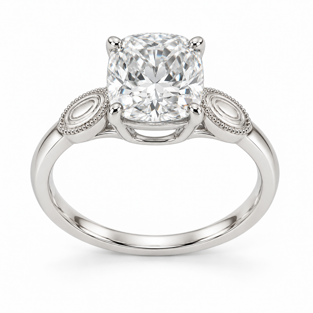 [metal:white-gold] Ophira Cartouche Solitaire Setting — front — One cushion centre in four corner claws in a compact open basket. At each shoulder a single small solid polished oval cartouche inset with engraved concentric oval lines, no stones. Cartouches lie flat along the top of the shank, merge into one slim plain band. Fine bead border on cartouches only, open U bridge beneath centre. [catalog-v4]