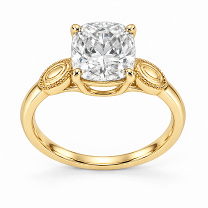 [metal:yellow-gold] Ophira Cartouche Solitaire Setting — front — One cushion centre in four corner claws in a compact open basket. At each shoulder a single small solid polished oval cartouche inset with engraved concentric oval lines, no stones. Cartouches lie flat along the top of the shank, merge into one slim plain band. Fine bead border on cartouches only, open U bridge beneath centre. [catalog-v4]