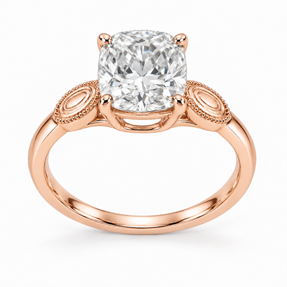 [metal:rose-gold] Ophira Cartouche Solitaire Setting — front — One cushion centre in four corner claws in a compact open basket. At each shoulder a single small solid polished oval cartouche inset with engraved concentric oval lines, no stones. Cartouches lie flat along the top of the shank, merge into one slim plain band. Fine bead border on cartouches only, open U bridge beneath centre. [catalog-v4]