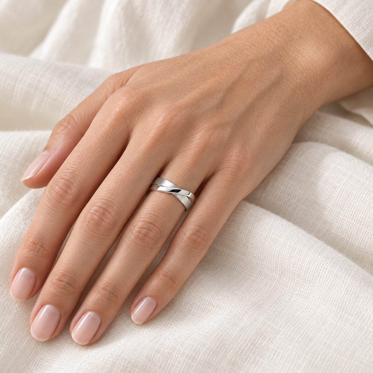 [metal:all] Orielle Ribbon Crossover Ring — worn — Human-worn styling illustration [catalog-v4]