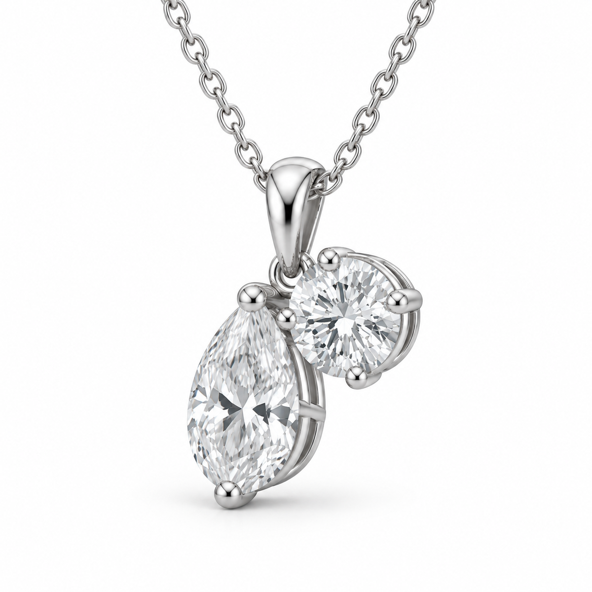 [metal:white-gold] Rosamund Toi et Moi Necklace — three-quarter — Pear and round diamond pendant, oblique studio view [catalog-v4]