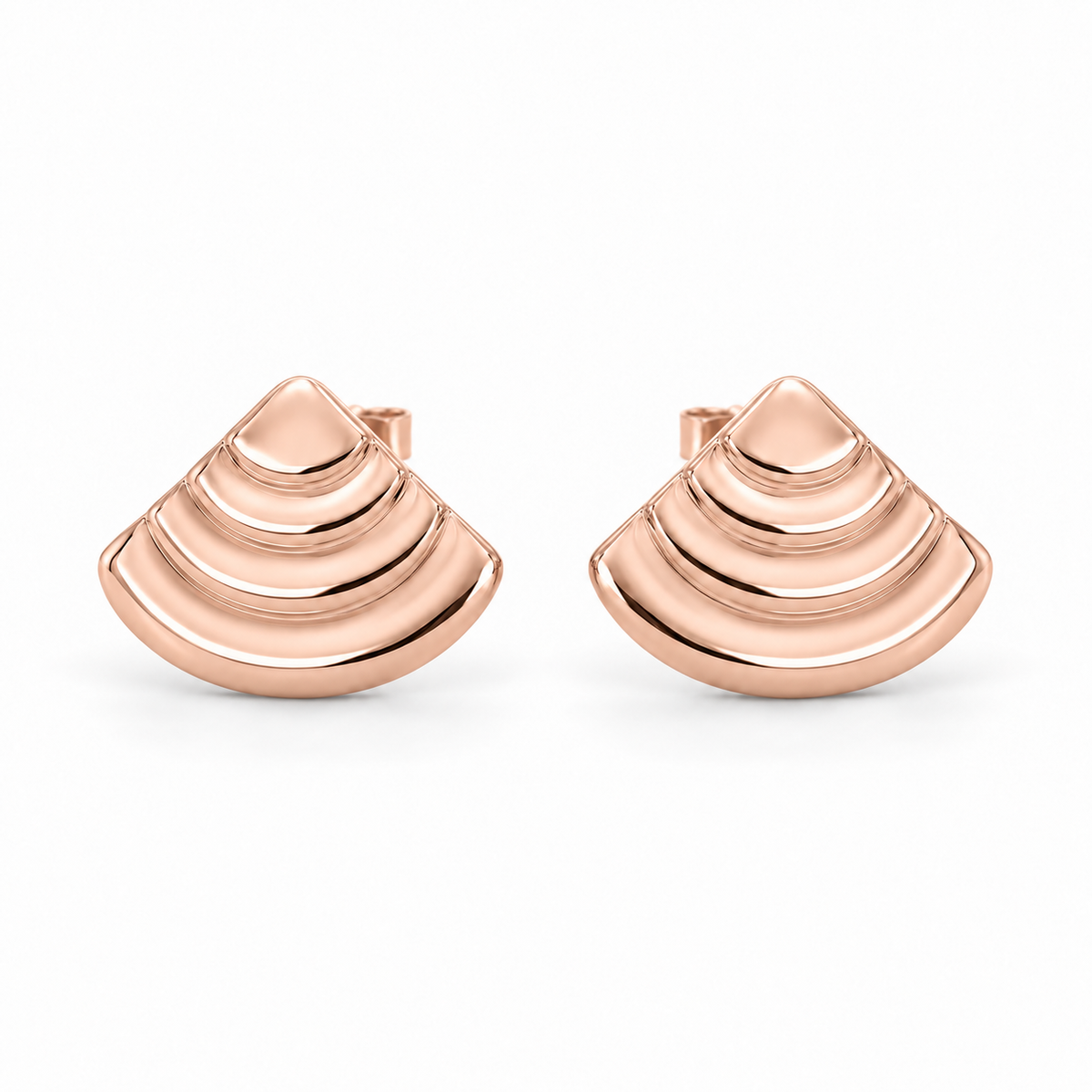 [metal:rose-gold] Rovelle Stepped Shell Studs — front — Matching pair of shallow domed fan-shell metal studs, each shell has exactly four broad concentric stepped arc terraces, smooth rounded lower edge and no radial pleats. Straight rear post and butterfly back. No diamonds. [catalog-v4]