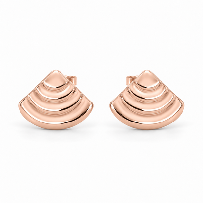 [metal:rose-gold] Rovelle Stepped Shell Studs — front — Matching pair of shallow domed fan-shell metal studs, each shell has exactly four broad concentric stepped arc terraces, smooth rounded lower edge and no radial pleats. Straight rear post and butterfly back. No diamonds. [catalog-v4]