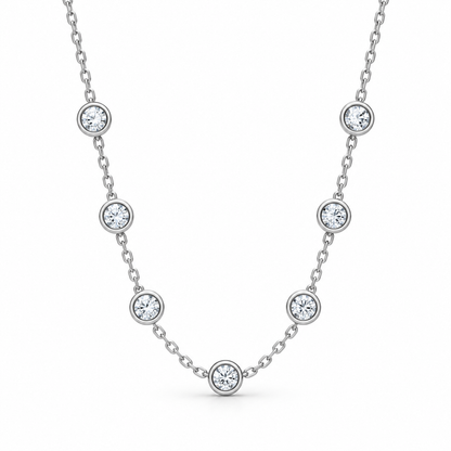 [metal:white-gold] Serenade Station Necklace — front — Seven bezel diamond stations, front studio view [catalog-v4]