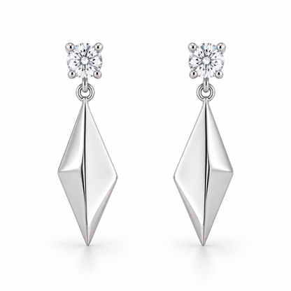 [metal:white-gold] Solivelle Kite Drop Earrings — front — Matching pair: each earring has one small round diamond stud in a four-claw basket, one tiny articulating jump ring and one solid polished asymmetric kite-shaped metal drop with a single folded central ridge. No diamonds on kite. Straight post and butterfly back. [catalog-v4]