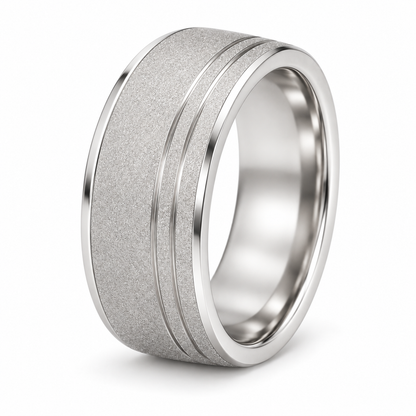 [metal:white-gold] Soren Sandblast Groove Band — three-quarter — broad matte sandblasted white gold band with two close parallel off-centre grooves near one edge, thin polished bevel borders no stones, three-quarter view [catalog-v4]