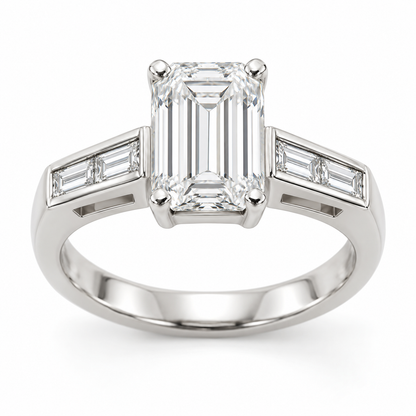 [metal:white-gold] Talisse Window Channel Setting — front — One north-south emerald-cut centre in four corner claws over a simple rectangular open basket. Each straight flat shoulder contains exactly two north-south baguette accents in one short straight channel with raised smooth rails. Beneath that channel is one small rectangular side window with a solid lower support. Plain single lower shank. Four baguette accents total. [catalog-v4]