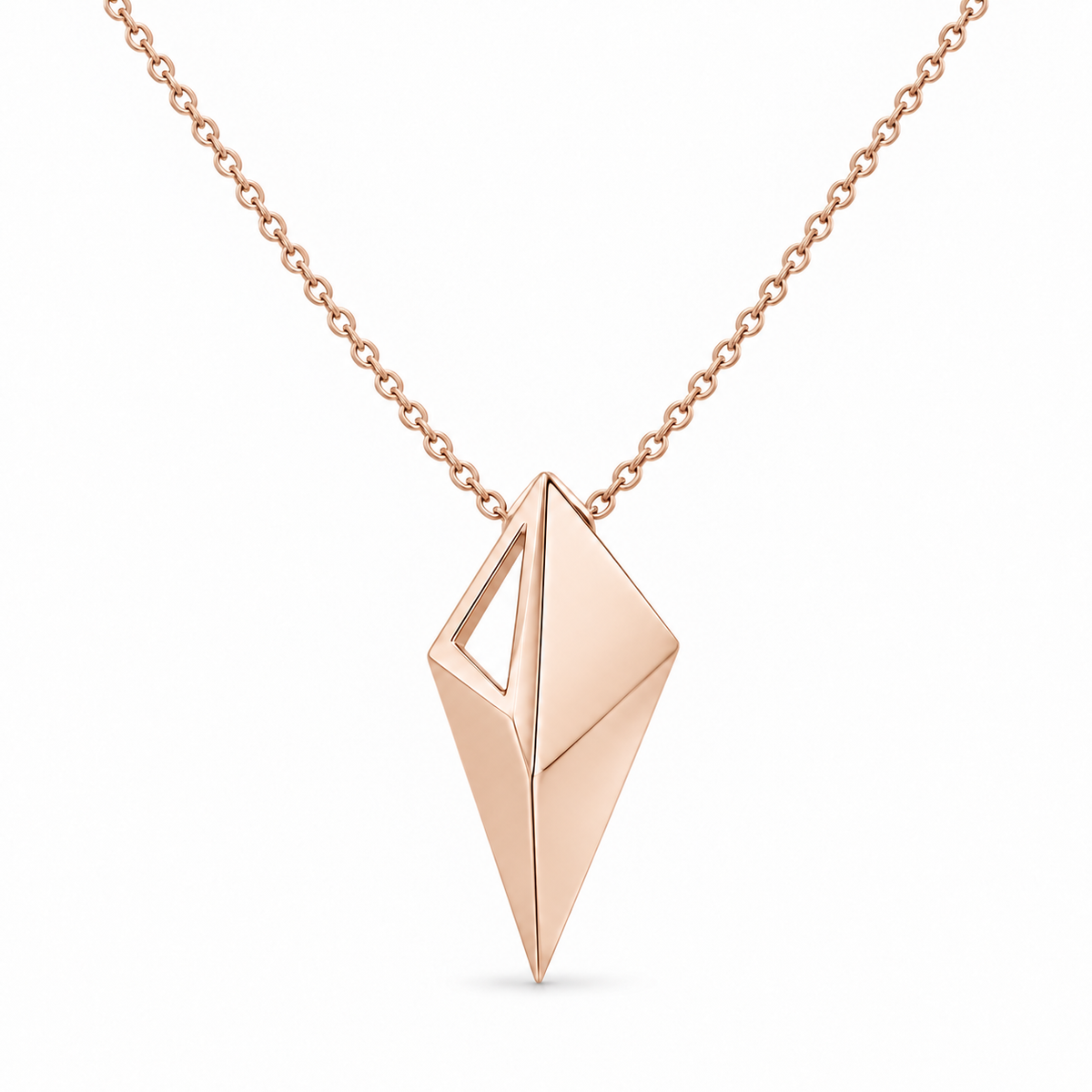 [metal:rose-gold] Virelia Folded Sail Necklace — front — One asymmetric solid folded triangular metal sail pendant, three crisp planar facets and one narrow open triangular aperture near the upper left edge. Single small hidden bail at top, fine cable chain, no stones. [catalog-v4]